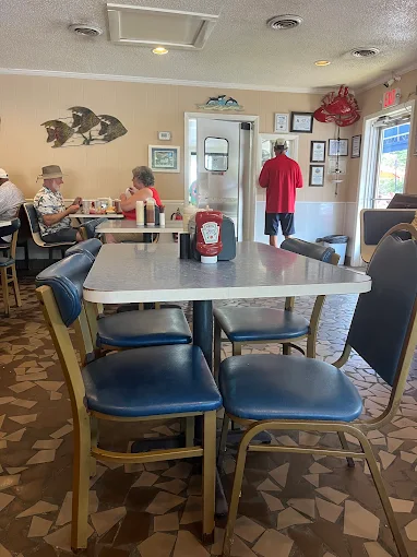 Dining room tables set with blue chairs